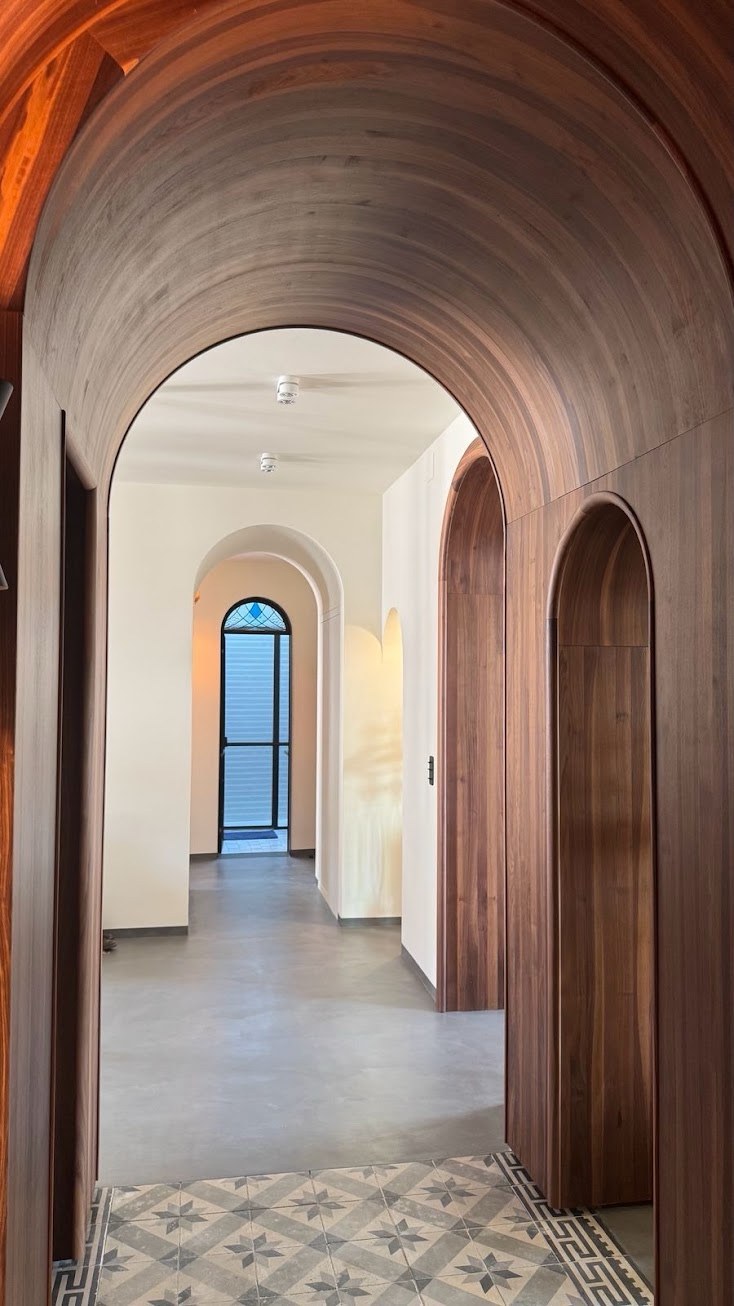 Intérieur rénové avec arches et sol en béton ciré
